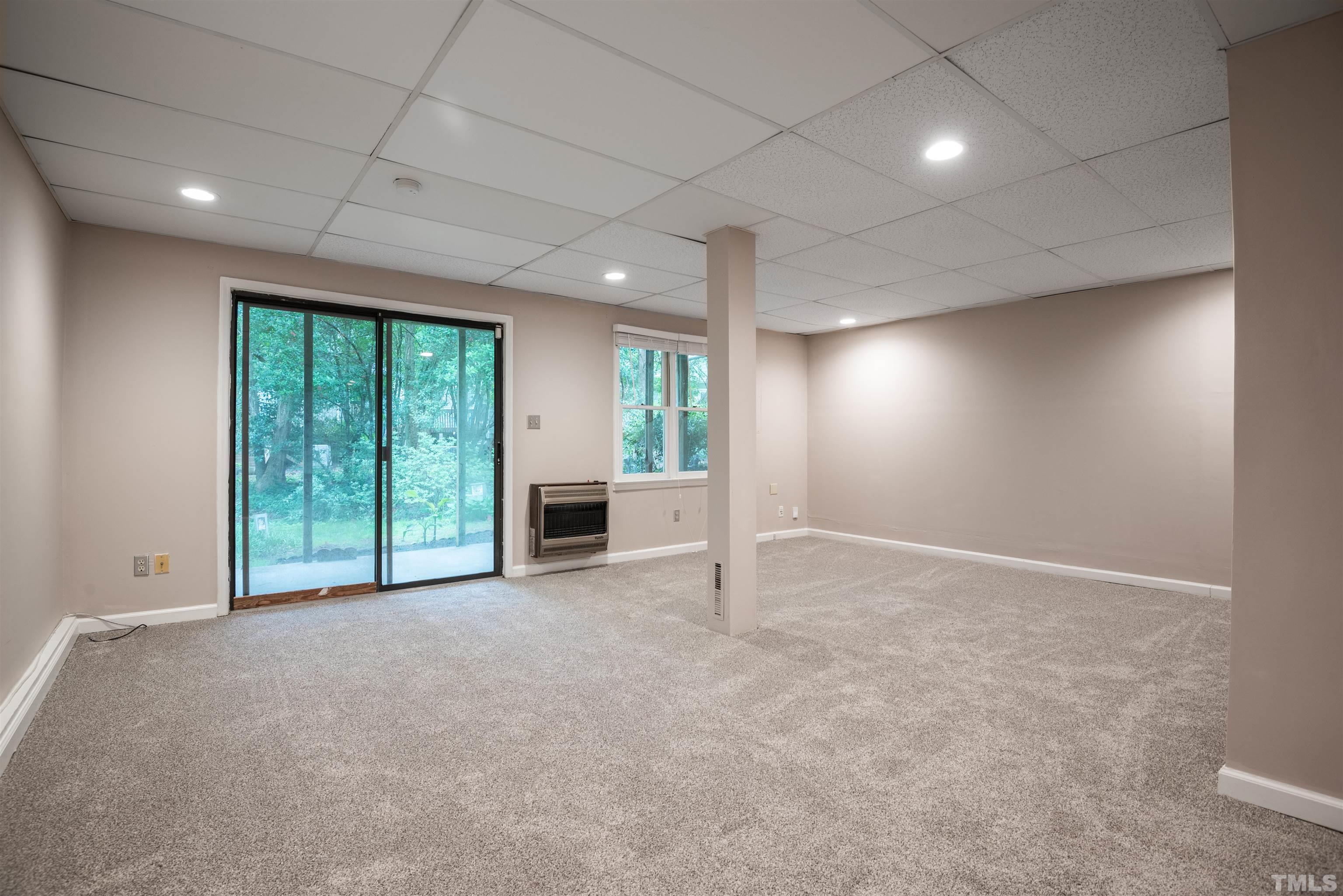 405 Oak Run Drive Raleigh, NC 27606 - Photo 54 of 83 an empty room with windows and fireplace