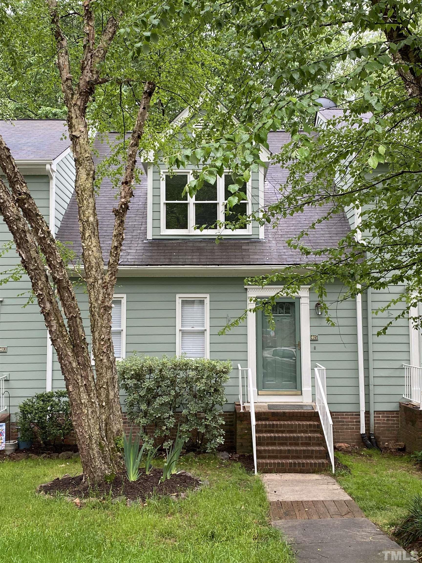 405 Oak Run Drive Raleigh, NC 27606 - Photo 79 of 83 a front view of a house with a garden
