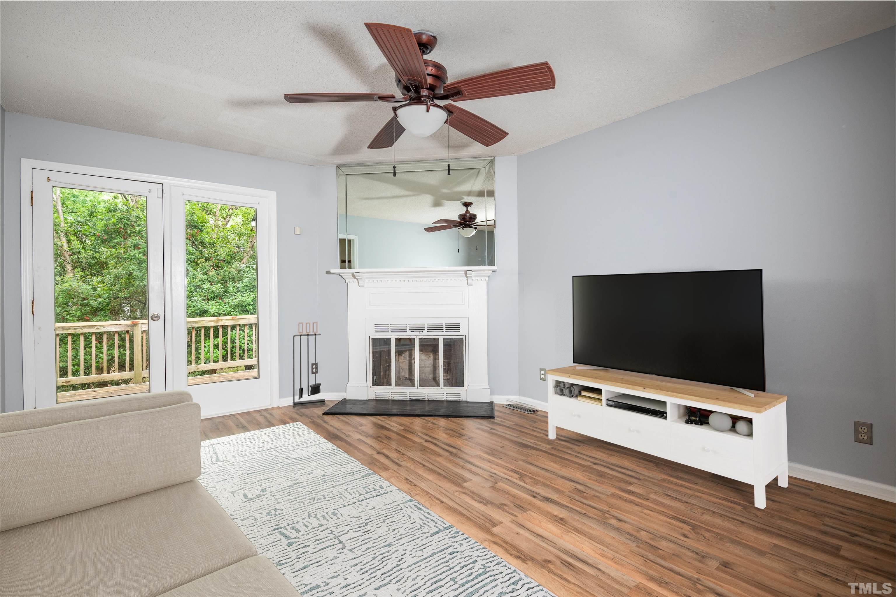 405 Oak Run Drive Raleigh, NC 27606 - Photo 8 of 83 a living room with furniture and a flat screen tv