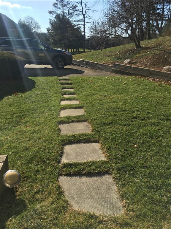 182 Windsor Ridge, Unit 52 New Castle, PA 16105 - Photo 20 of 25 Back sidewalk to garage/drive