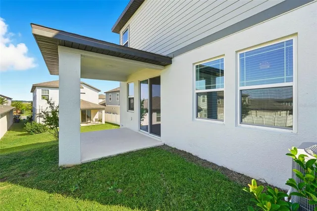 a view of an house with backyard porch and sitting area