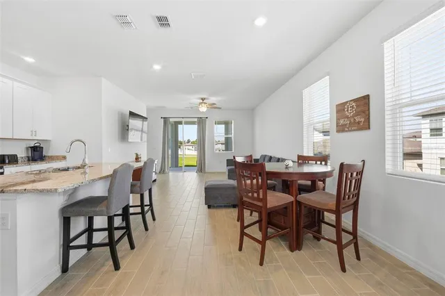 a view of a dining room with furniture and window