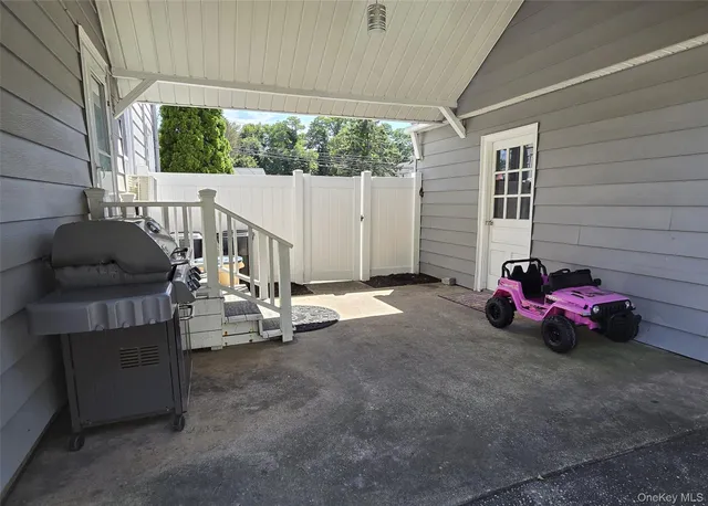 a view of a house with a patio and a yard