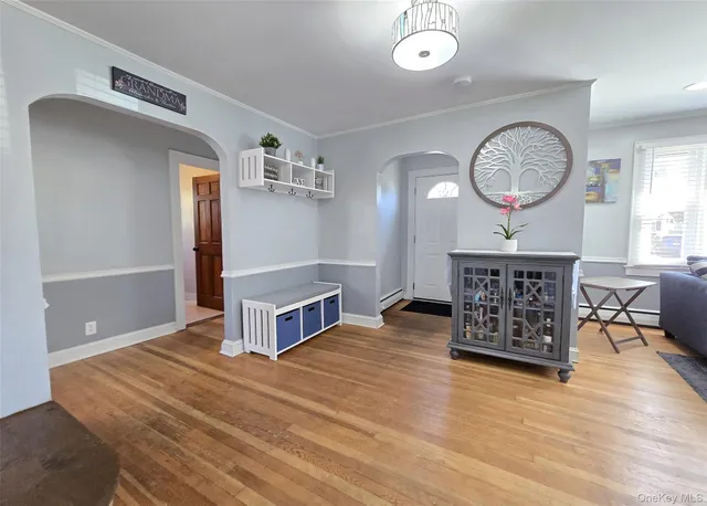 a view of a room with wooden floor table and chairs