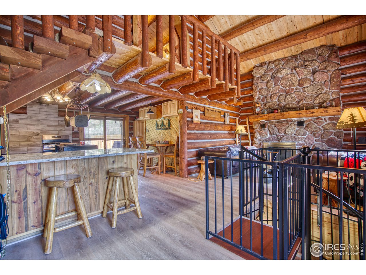 1761 Redbluff Road Livermore, CO 80536 - Photo 16 of 40 From the deck entry to the kitchen and family room. Spiral staircase to the lower level, loft primary above.