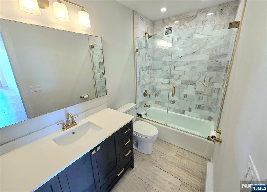 151 Prospect Avenue, Unit 19A Hackensack, NJ 07601 - Photo 9 of 17 a bathroom with a sink a toilet and shower