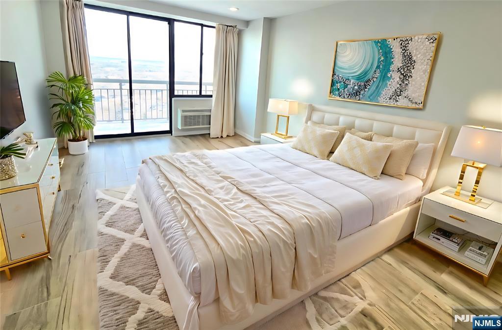 151 Prospect Avenue, Unit 19A Hackensack, NJ 07601 - Photo 10 of 17 a bedroom with a bed and a large window