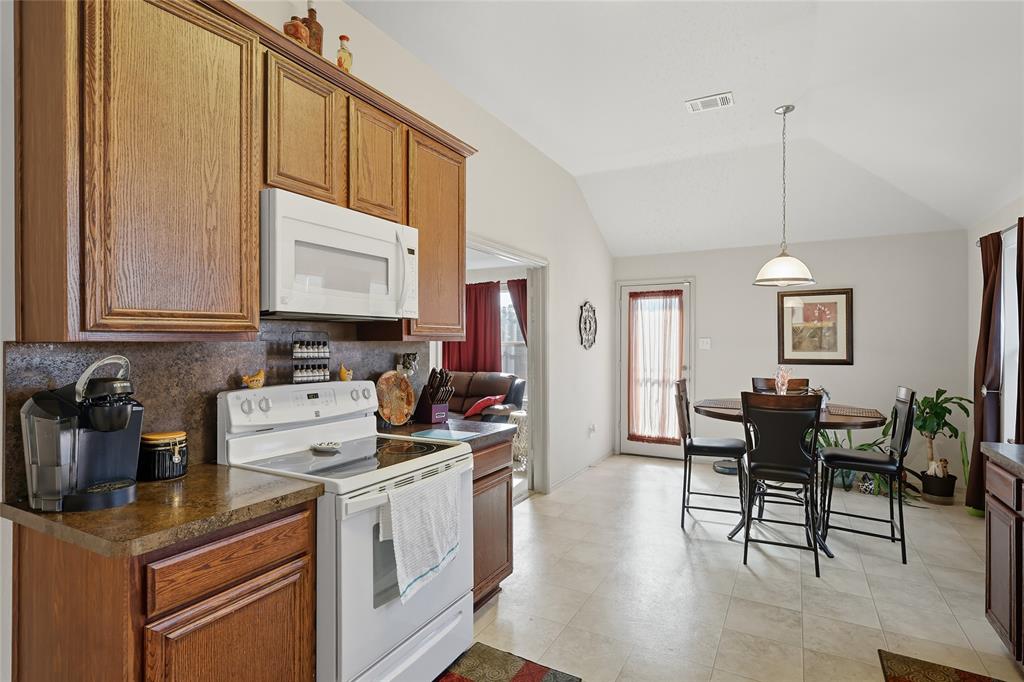 2708 Stockton Street Denton, TX 76209 - Photo 12 of 40 a kitchen that has a cabinets counter space and a dining table
