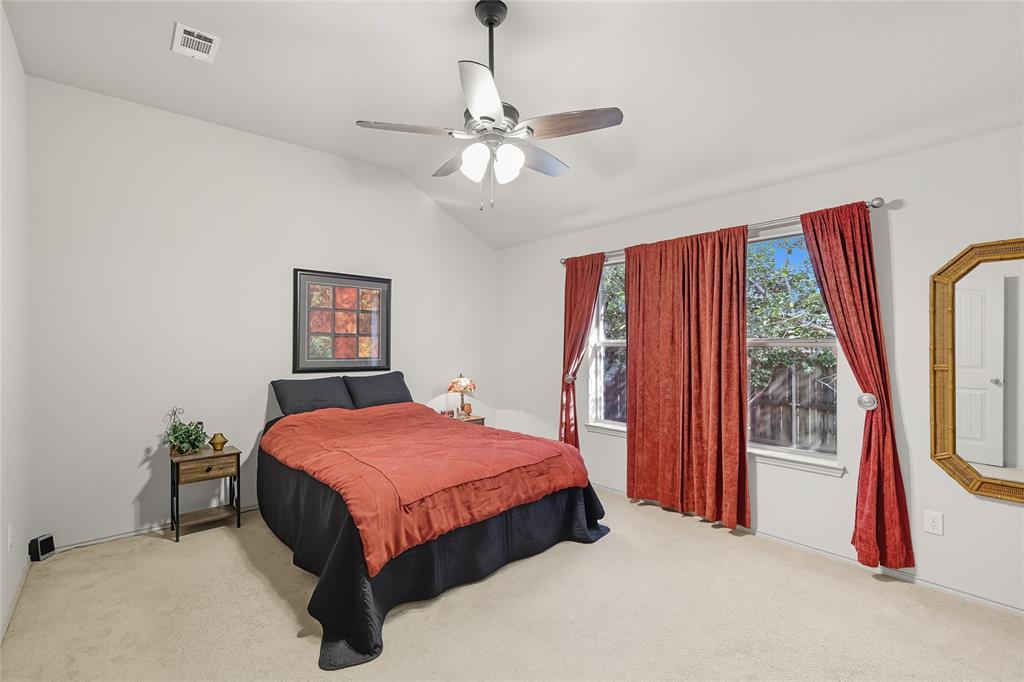 2708 Stockton Street Denton, TX 76209 - Photo 18 of 40 a bedroom with a bed and a flat screen tv