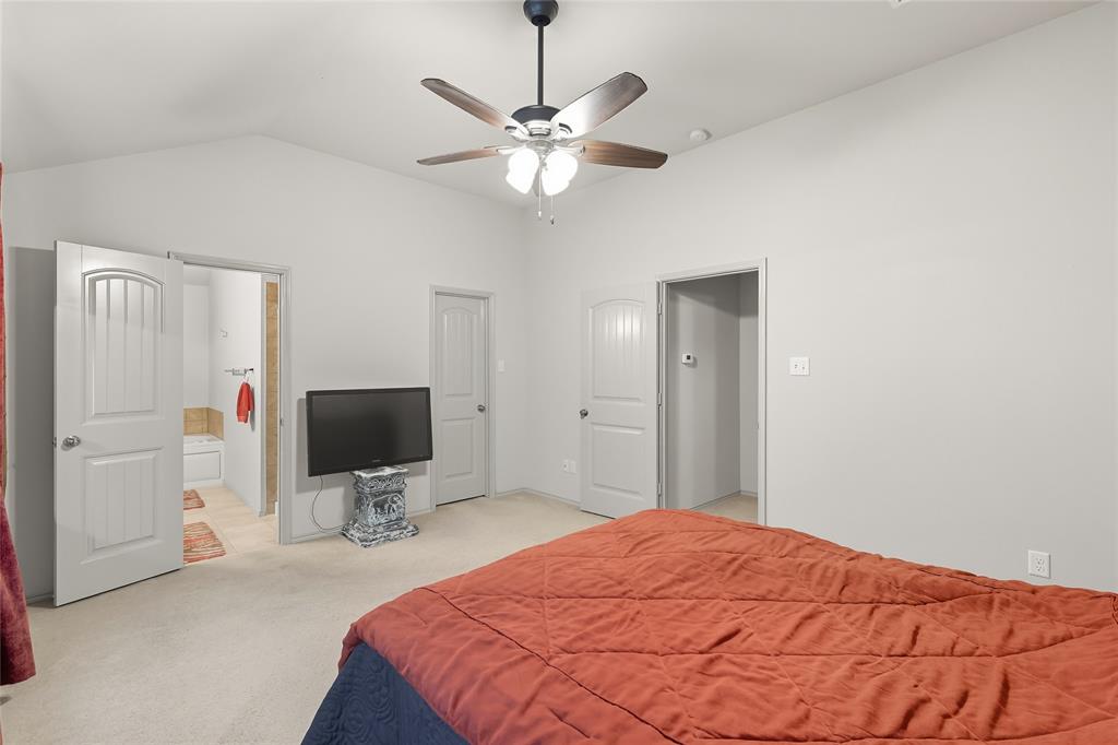 2708 Stockton Street Denton, TX 76209 - Photo 19 of 40 a bedroom with a bed and a flat tv screen on the dresser