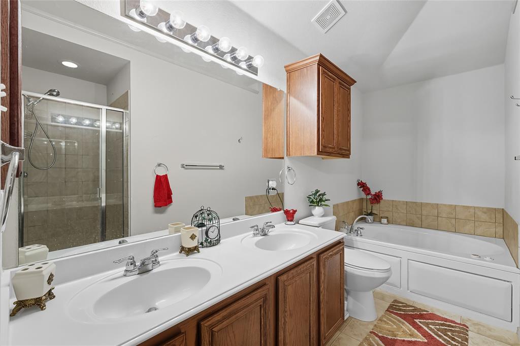2708 Stockton Street Denton, TX 76209 - Photo 20 of 40 a bathroom with a sink vanity granite toilet and shower