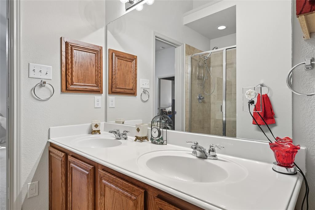 2708 Stockton Street Denton, TX 76209 - Photo 22 of 40 a bathroom with a sink vanity and a mirror