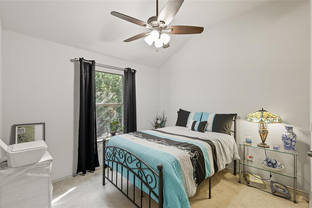 2708 Stockton Street Denton, TX 76209 - Photo 23 of 40 a bedroom with a bed and a chandelier