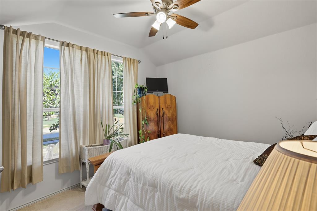 2708 Stockton Street Denton, TX 76209 - Photo 25 of 40 a bedroom with a bed and a chandelier