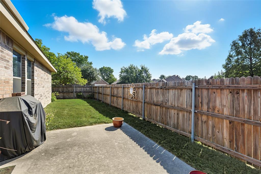 2708 Stockton Street Denton, TX 76209 - Photo 29 of 40 a view of a backyard with wooden fence