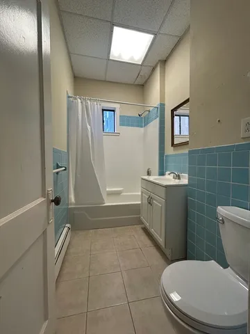 a bathroom with a toilet a sink and bathtub