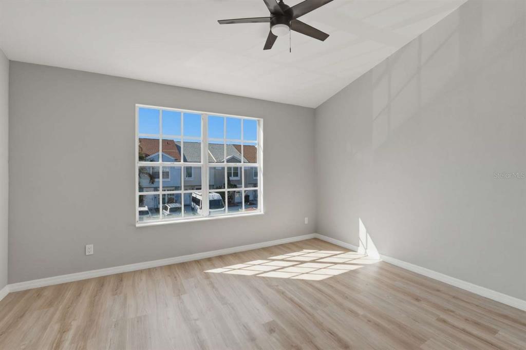 6600 121st Avenue, Unit 3 Largo, FL 33773 - Photo 17 of 27 an empty room with wooden floor and windows