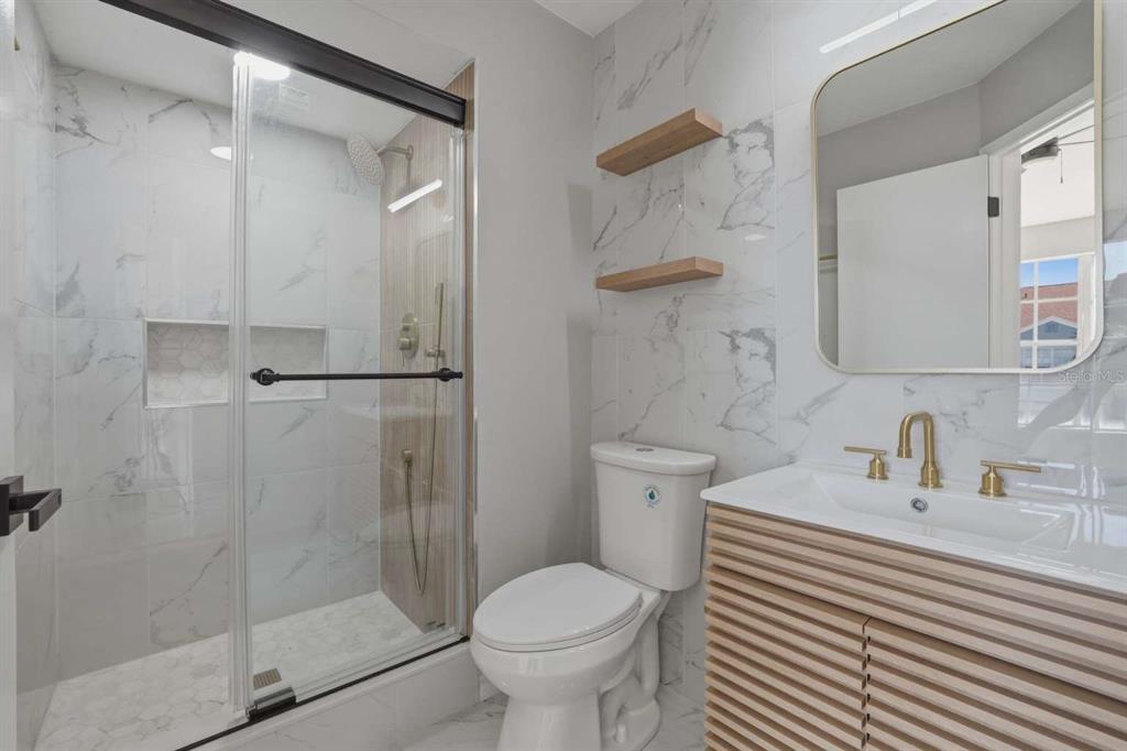 6600 121st Avenue, Unit 3 Largo, FL 33773 - Photo 18 of 27 a bathroom with a sink toilet and shower
