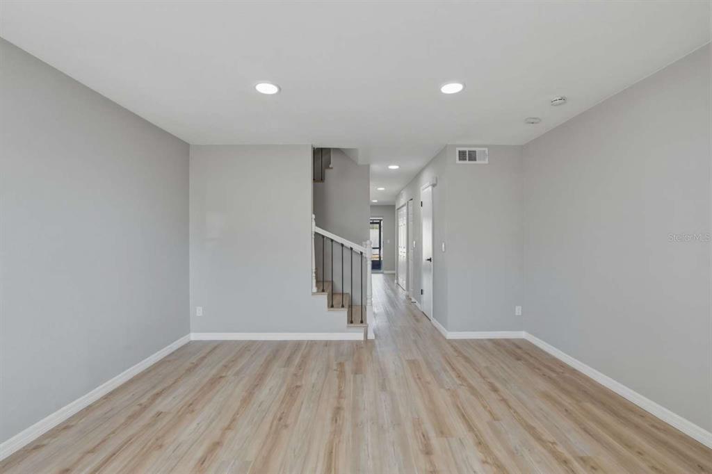 6600 121st Avenue, Unit 3 Largo, FL 33773 - Photo 3 of 27 a view of empty room with wooden floor