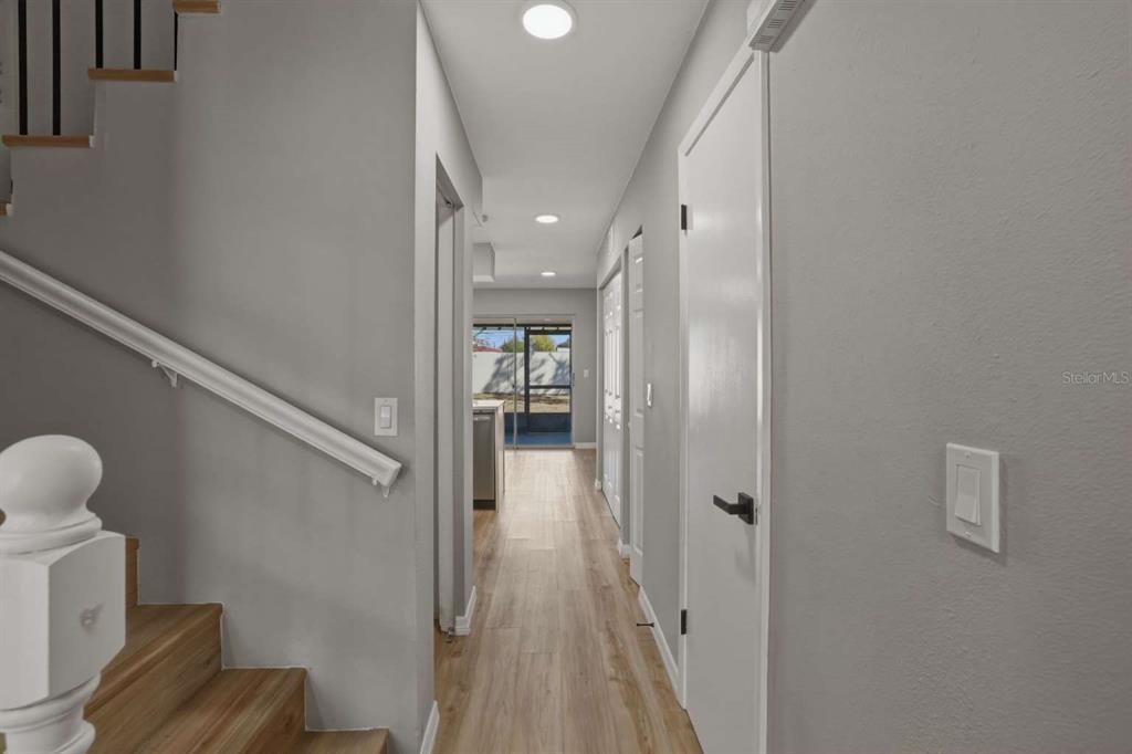 6600 121st Avenue, Unit 3 Largo, FL 33773 - Photo 6 of 27 a view of a hallway with wooden floor and staircase