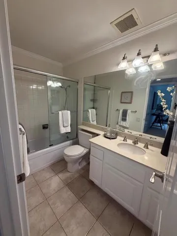 a bathroom with a double vanity sink toilet and shower