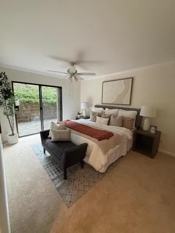 a spacious bedroom with a bed and large window