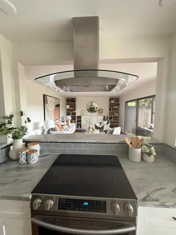 a kitchen with a stove and a white cabinets