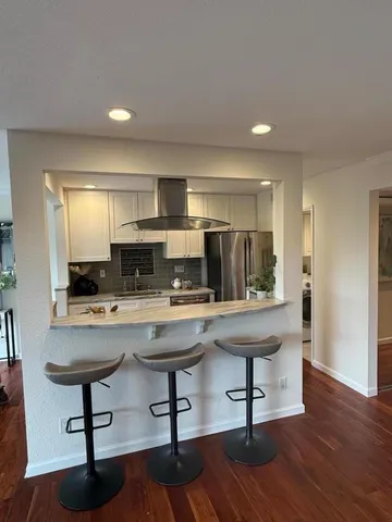 a view of kitchen with cabinets and wooden floor