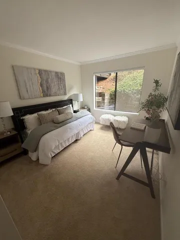 a bedroom with a bed and a table