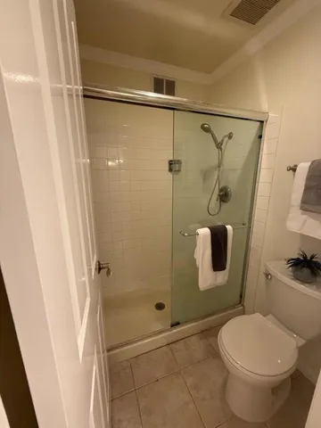 a bathroom with a toilet and a shower