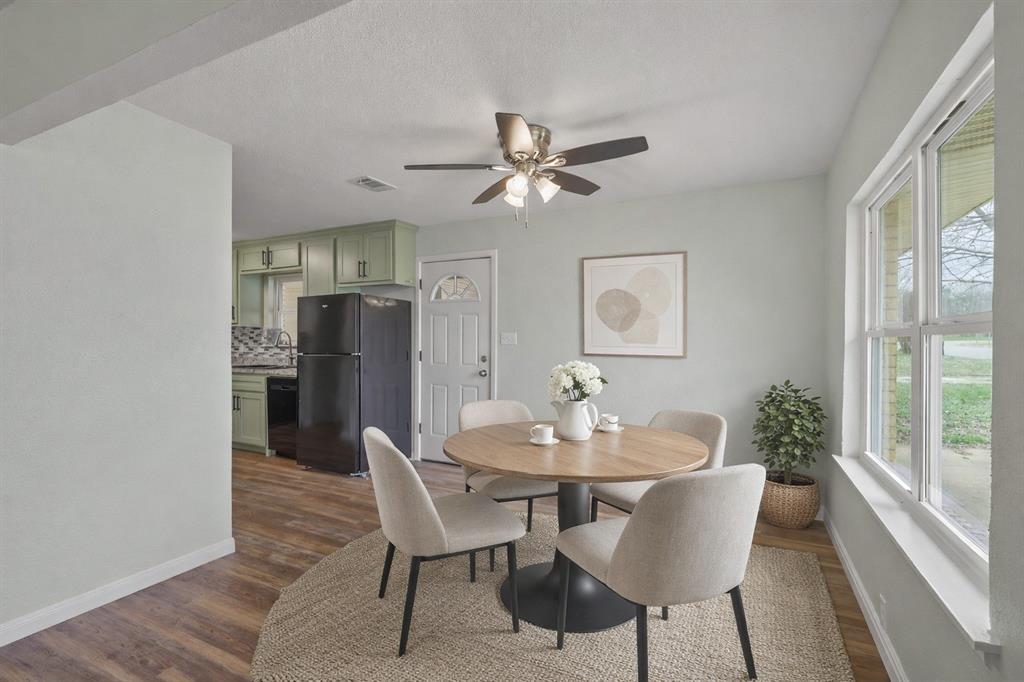 732 Bullock Street Denison, TX 75020 - Photo 3 of 29 a dining room with furniture a chandelier and wooden floor