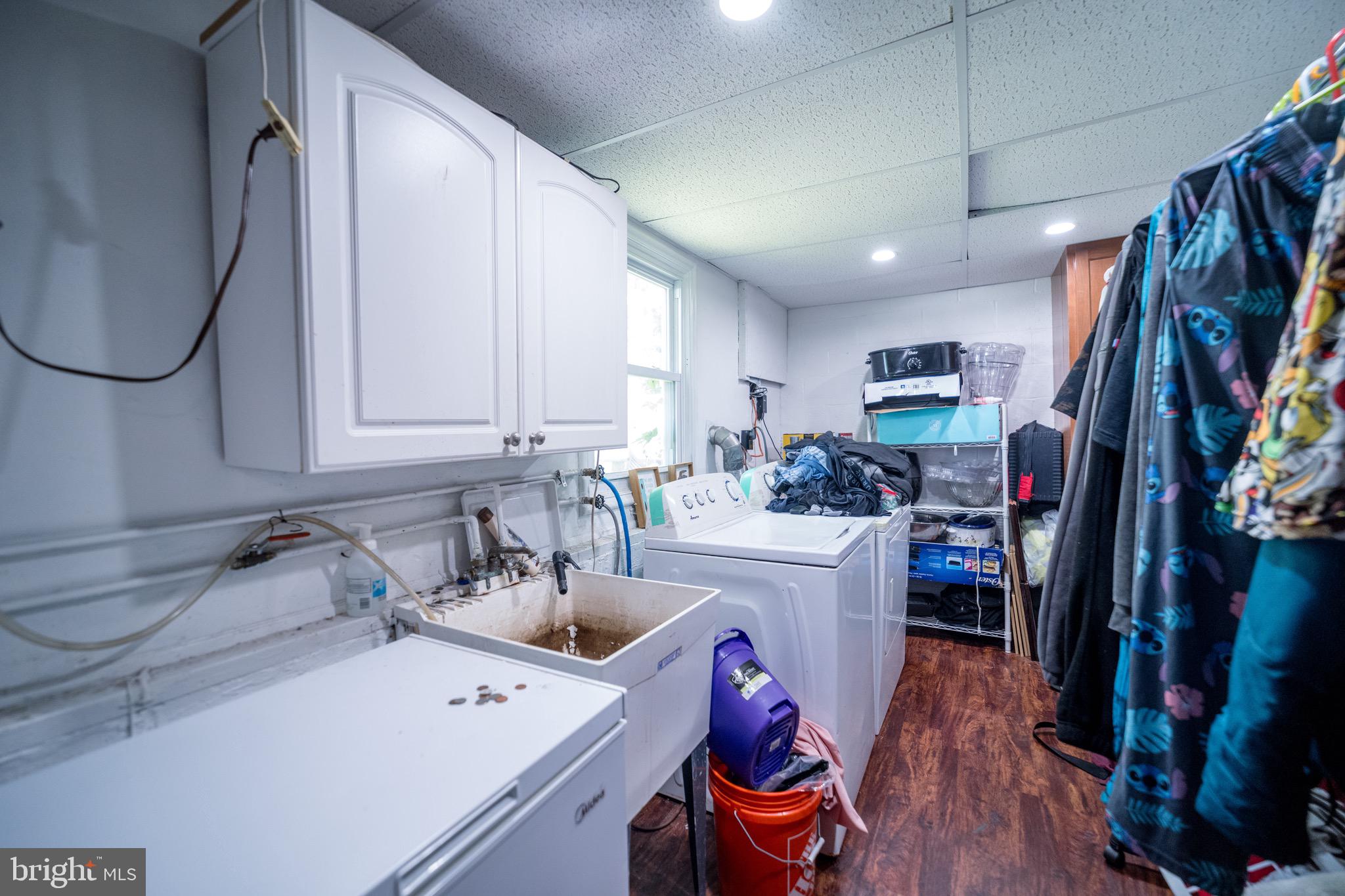 4125 Ronis Road Pikesville, MD 21208 - Photo 22 of 40 a kitchen that has a sink cabinets and wooden floor
