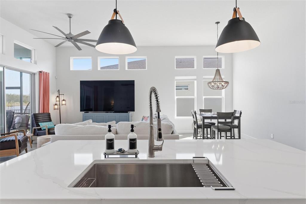 270 Azure Mist Way Daytona Beach, FL 32124 - Photo 20 of 71 a kitchen with a sink a chandelier and a stove