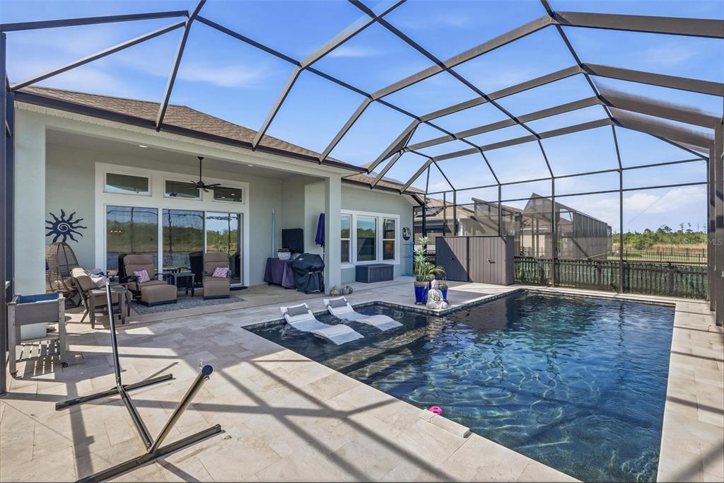 270 Azure Mist Way Daytona Beach, FL 32124 - Photo 42 of 71 a view of a patio with table and chairs under an umbrella