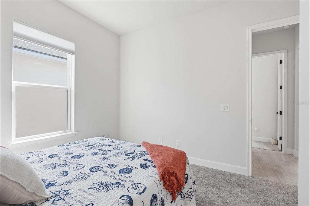 270 Azure Mist Way Daytona Beach, FL 32124 - Photo 56 of 71 a bedroom with a bed and a window