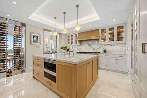 a kitchen with a stove kitchen island and stainless steel appliances