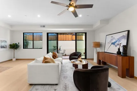 a living room with furniture and a view of kitchen