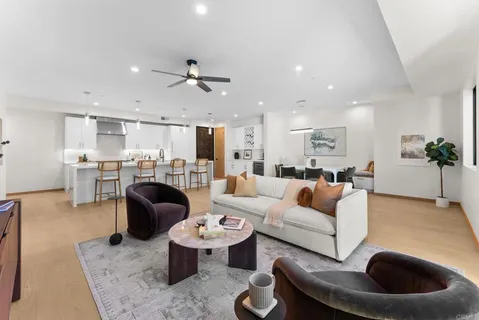 a living room with furniture large window and flat screen tv