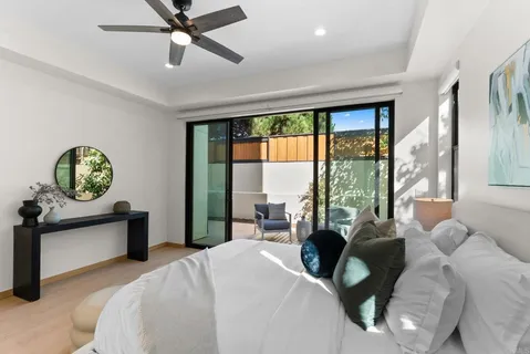 a bedroom with a bed and a painting on the wall