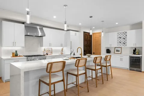 a kitchen with cabinets and chairs in it