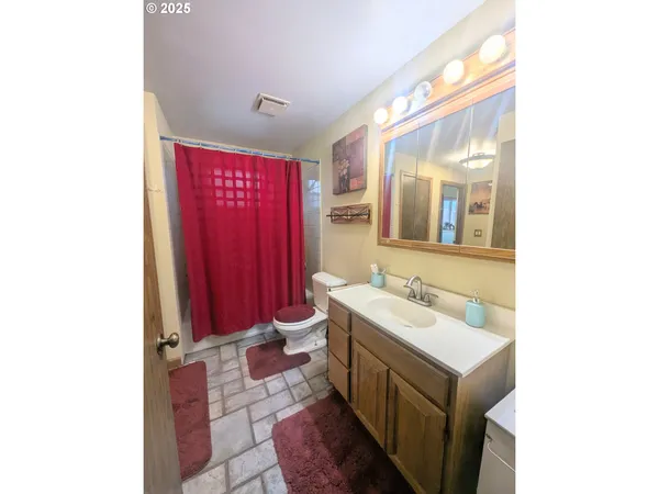 a bathroom with a toilet a sink and a mirror