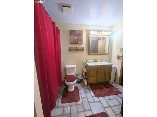 a bathroom with a sink toilet and mirror
