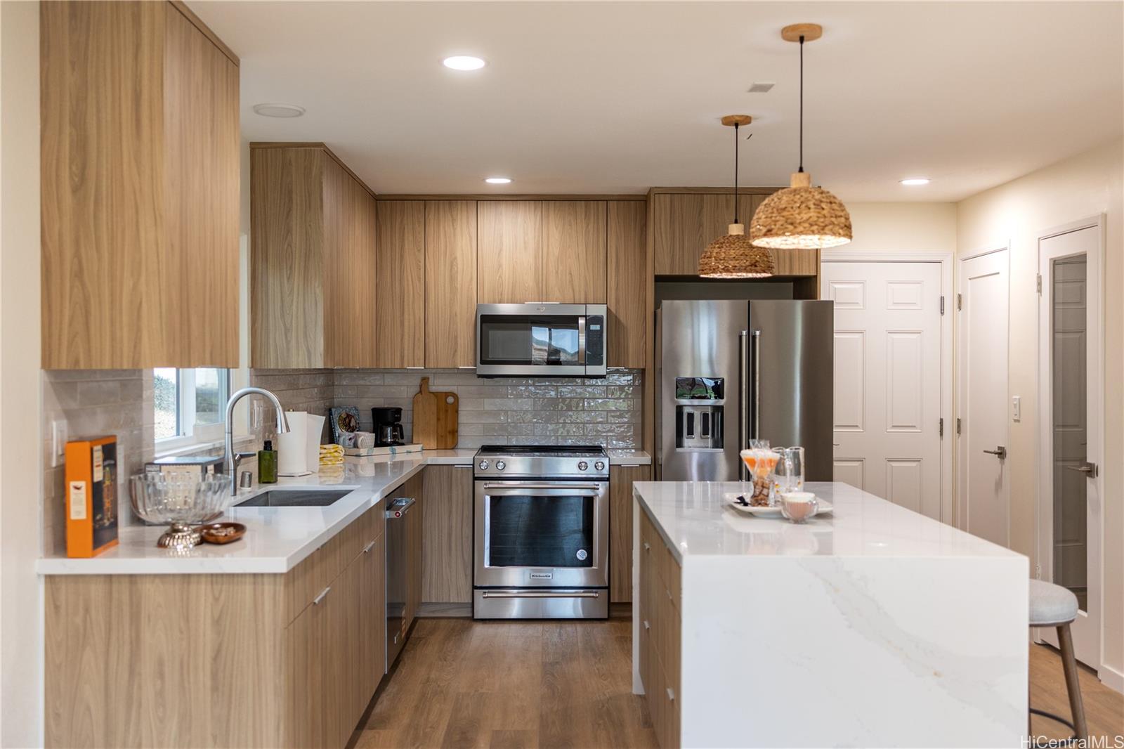 92-1274 Palahia Street Kapolei, HI 96707 - Photo 1 of 11 a kitchen with kitchen island a sink stainless steel appliances and cabinets