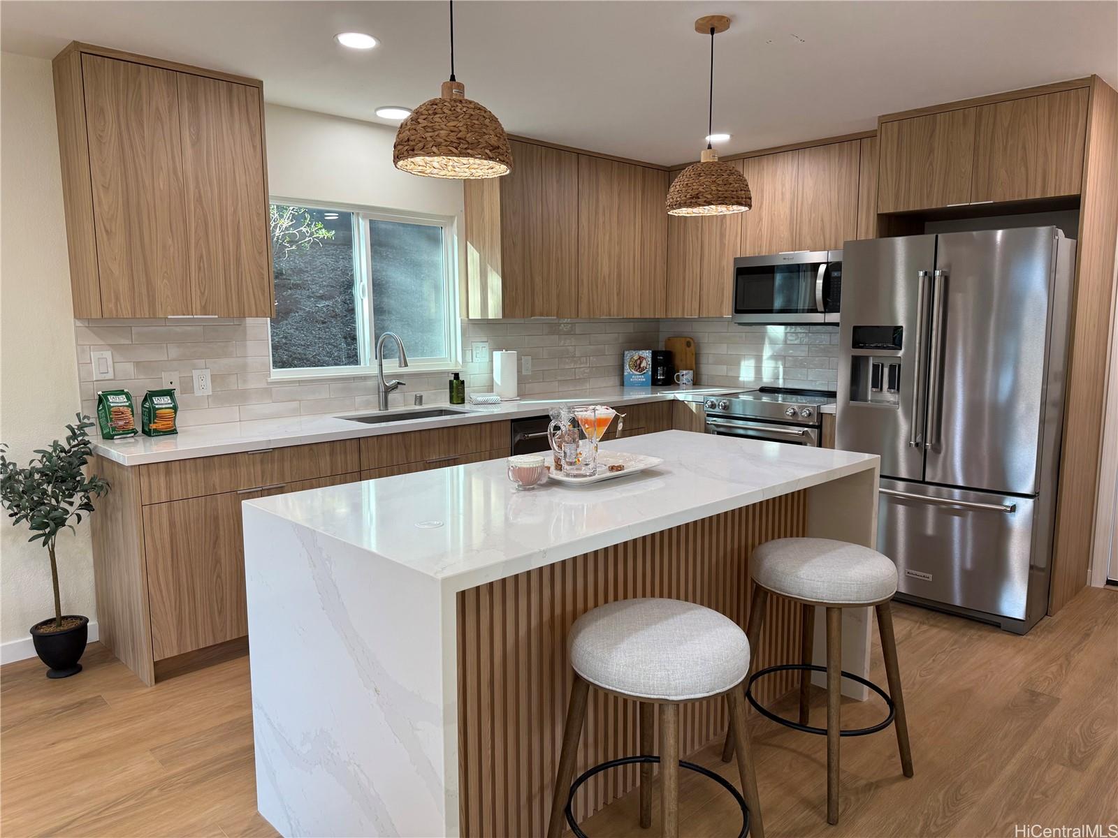92-1274 Palahia Street Kapolei, HI 96707 - Photo 2 of 11 a kitchen with stainless steel appliances granite countertop a sink a stove a refrigerator and island with wooden floor