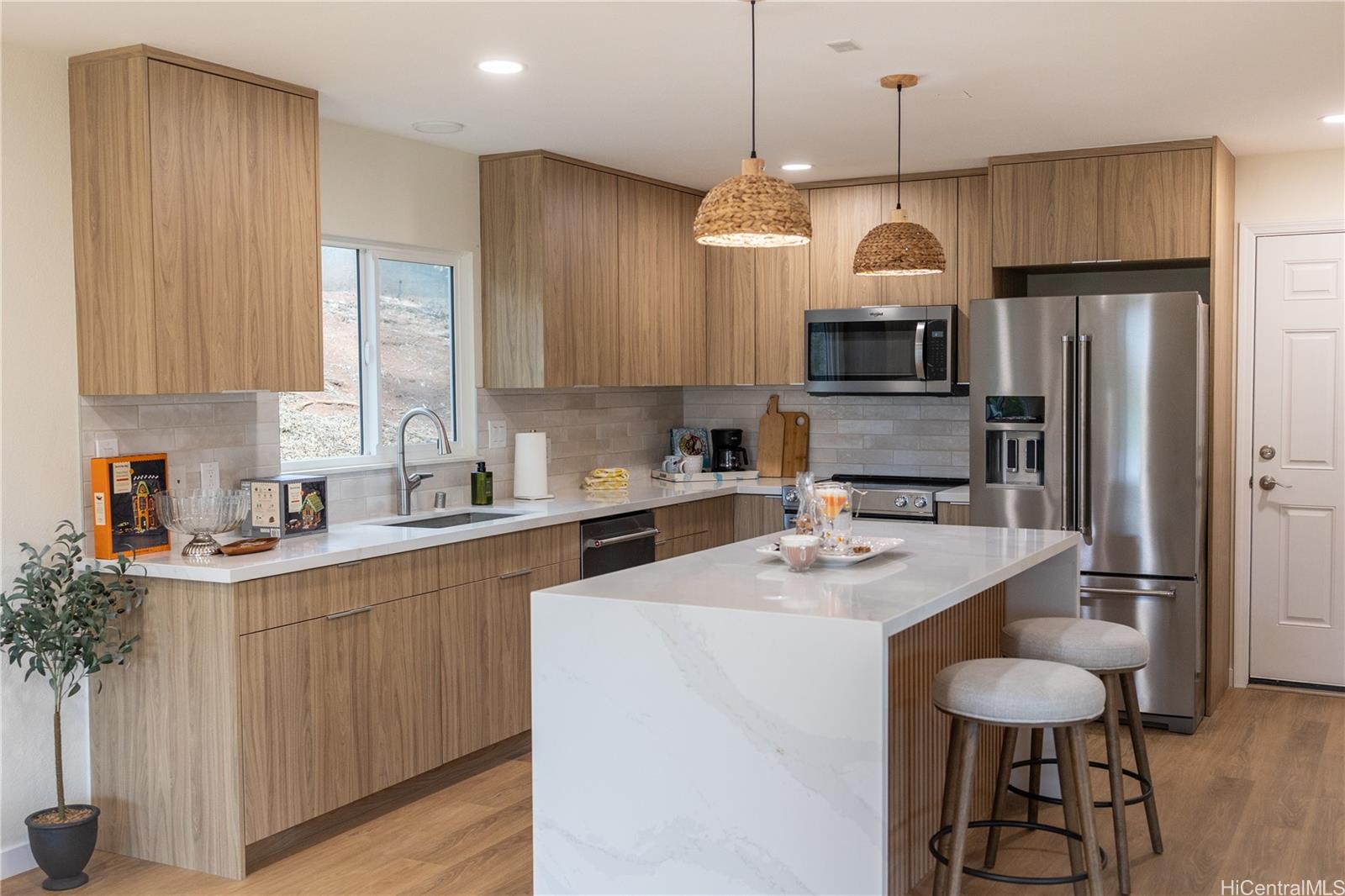92-1274 Palahia Street Kapolei, HI 96707 - Photo 3 of 11 a kitchen with stainless steel appliances granite countertop a sink a stove a refrigerator and island with wooden floor