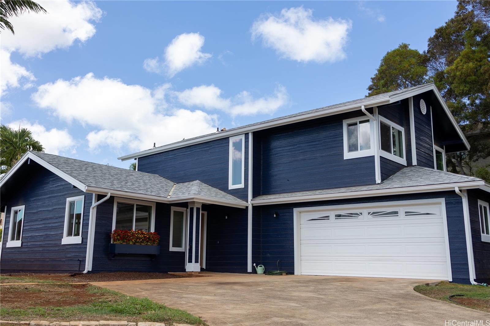 92-1274 Palahia Street Kapolei, HI 96707 - Photo 4 of 11 a front view of a house with a yard and garage