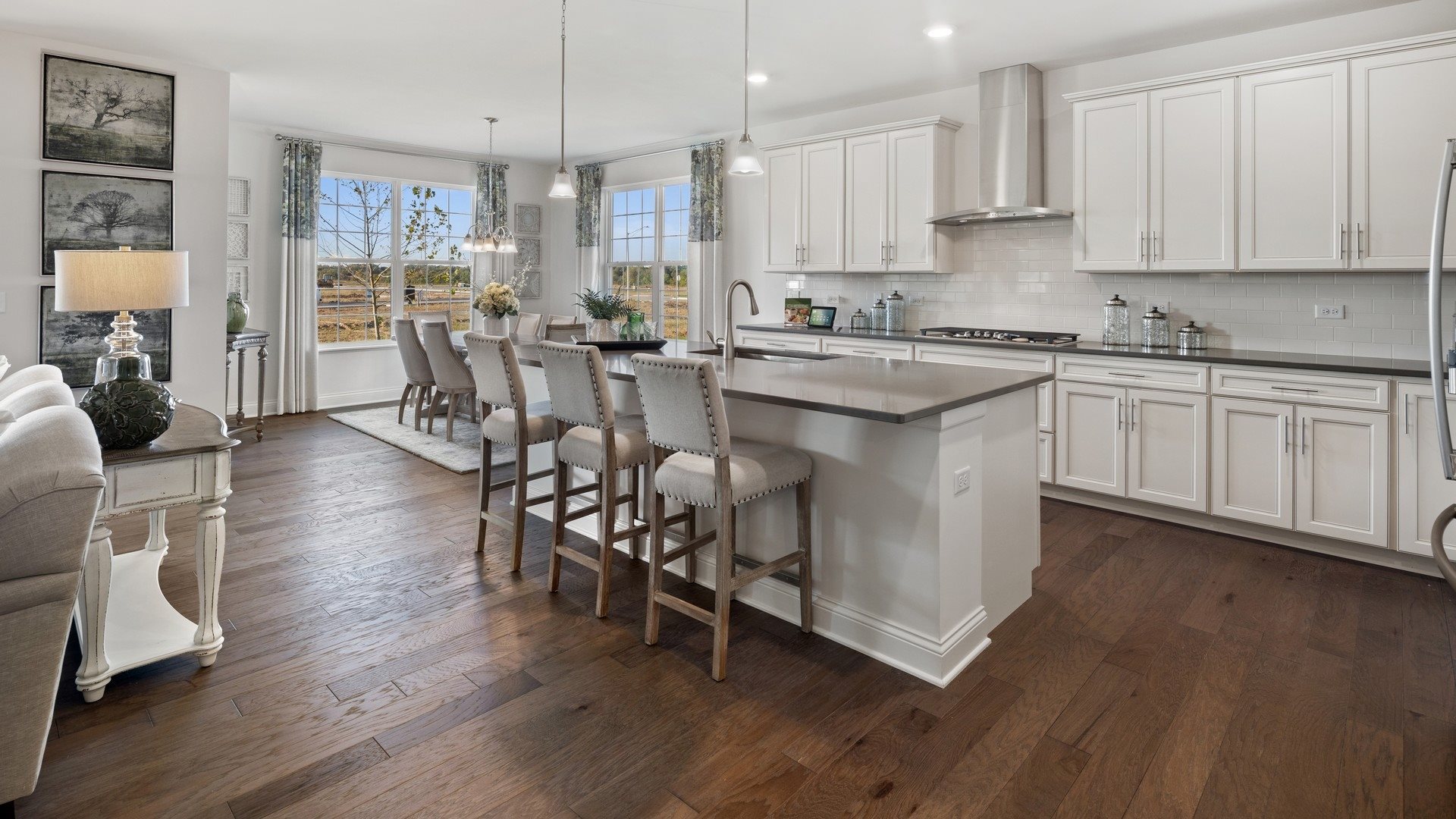 1804 Chandolin Road Elgin, IL 60124 - Photo 2 of 37 a kitchen with stainless steel appliances granite countertop wooden floors and table