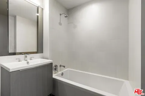 a white bath tub sitting next to a white sink