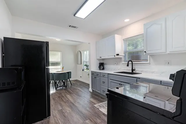 a kitchen with a sink stove and refrigerator