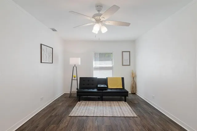 a view of bedroom with wooden floor and ceiling fan